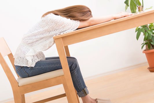 girl sleeping on table