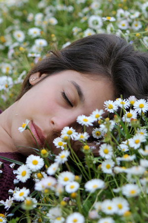 woman sleeping on back in grass with head turned sideways