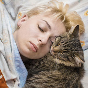 woman taking nap with cat