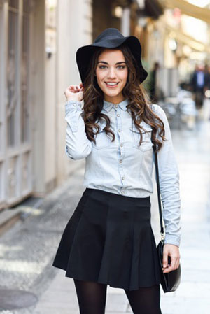 women in long sleeve denim shirt wearing black skirt