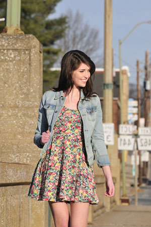 woman wearing denim jacket with floral print dress