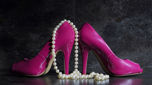 pink high heels and pearl necklace