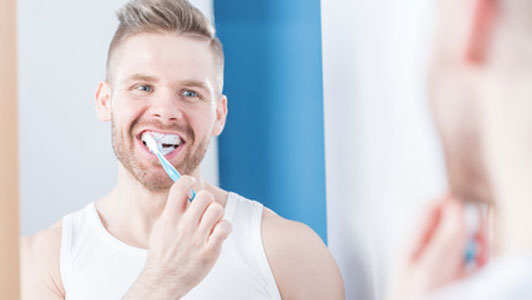 guy brushing teeth
