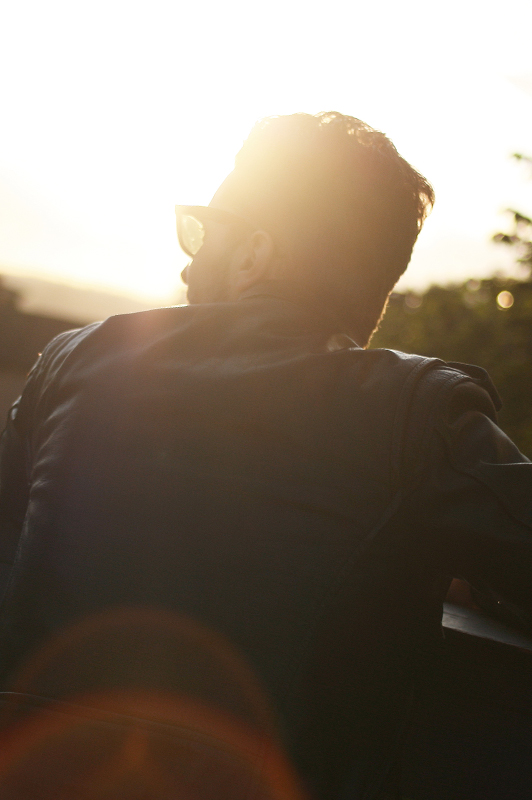 Guy with a black leather jacket and sunglasses.