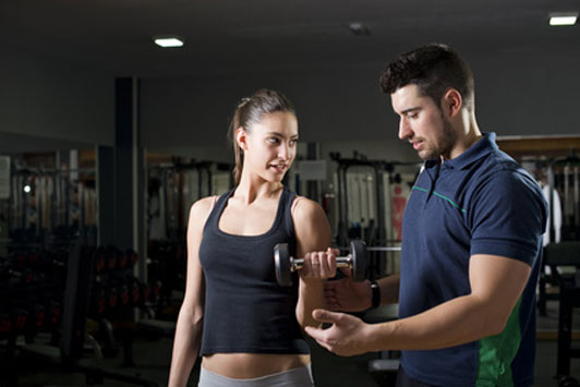 guy helping girl workout