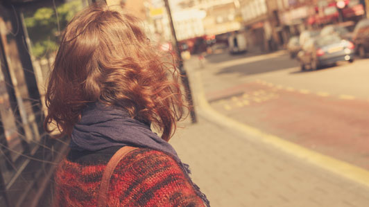 young woman looking on street