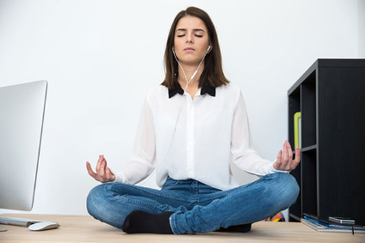 woman meditating on desk